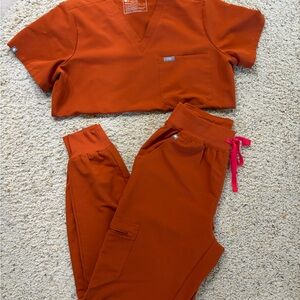 Figs Vibrant Orange Scrub Set with Pink Accents